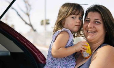 A mother holding her daughter.