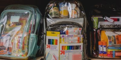 Backpacks filled with canned food and school supplies.