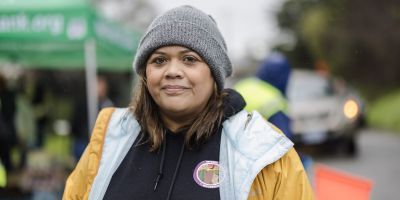 A food bank worker smiling.
