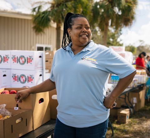 A woman next to food boxes.