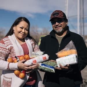 Trish and Jake holding food received